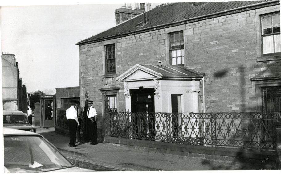 Police outside the Roseangle home where the murder occurred in 1980.