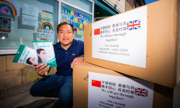 Andy Chan with boxes of facemasks