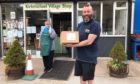 Blair Athol Distillery employees distribute free hand sanitiser to Kirkmichael Village Shop