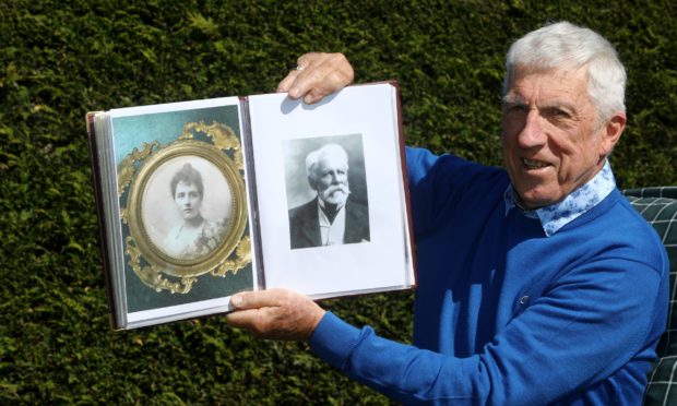 Ladybank Golf Club historian Bob Drummond at home in Ladybank today, holding photos of Catherine Maitland Soues and her husband F.W. Foster