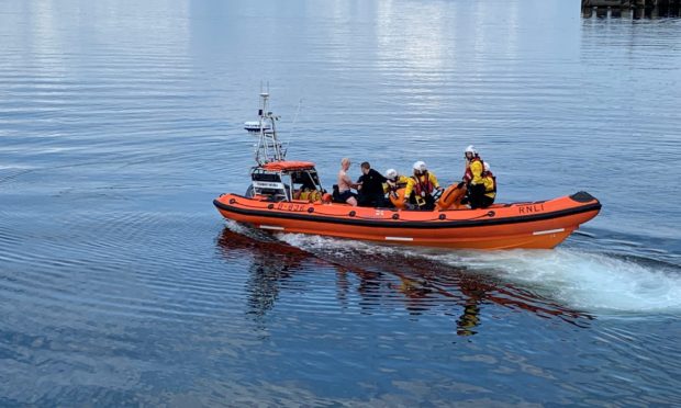 The men safely in the lifeboat.