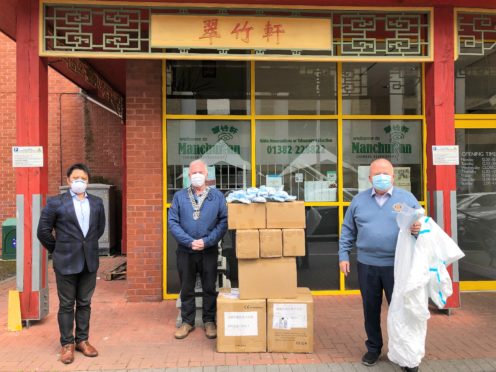 David Lu of the Manchurian restuarant in Dundee (left) with Forfar Rotary president Doug McFarlane and Rotarian David Valentine at the earlier masks handover.