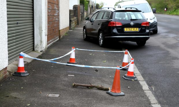 The scene at Kinghorne Road in Dundee where a man collapsed before his death.