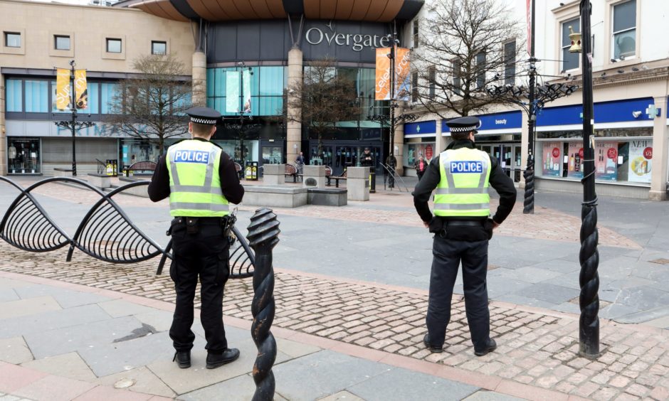 deserted Dundee city centre with two police officers.
