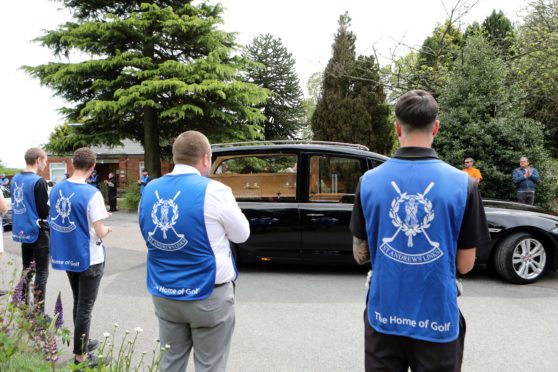 The funeral of Ralf Coutts  at Dundee Crematorium with St Andrews caddies and Keptie Friends clapping the hearse.