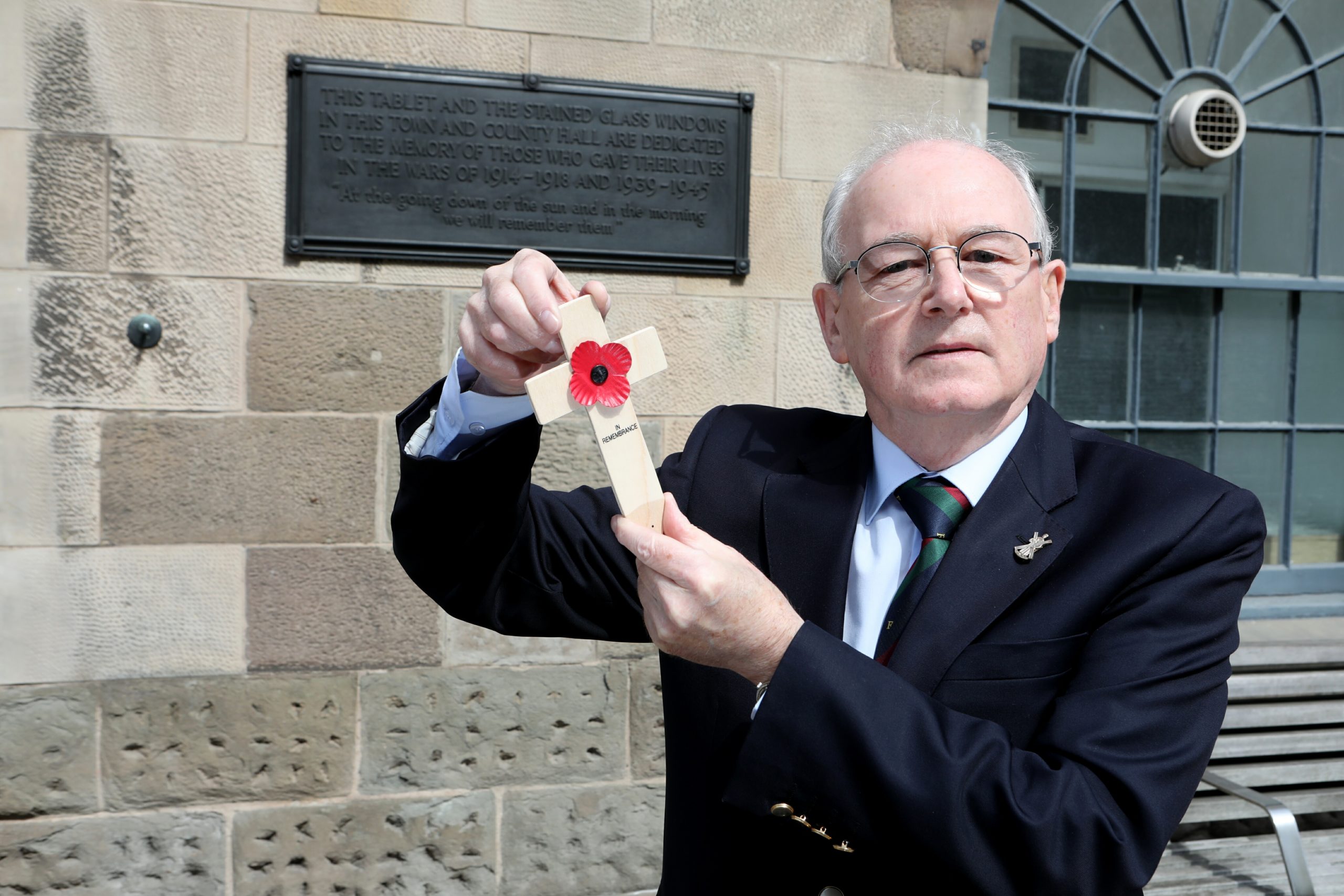 Ron Scrimgeour places a memorial cross to New Zealand namesake Sergeant Ralph Scrimgeour each Armistice Day.