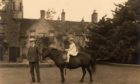 A young Princess Elizabeth, later to become Queen, on her black mare, Betty with her groom, Mr Smith, at Glamis Castle.