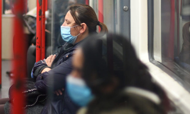 Passengers wearing masks on a train.