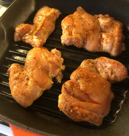 chicken cooking on a grill