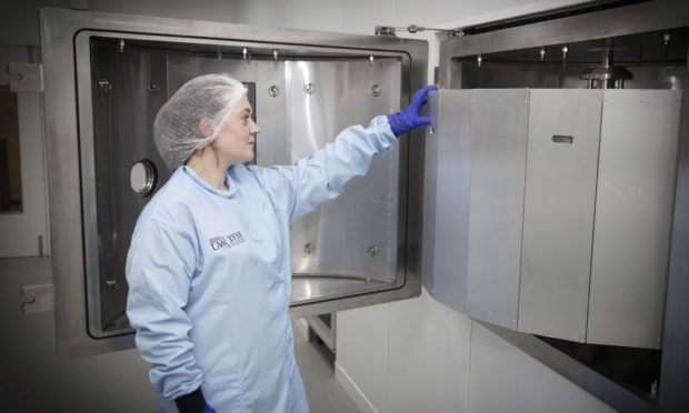 UWS unveils new multimillion pound thin films lab. A lab worker uses a microwave plasma assisted sputter deposition system.