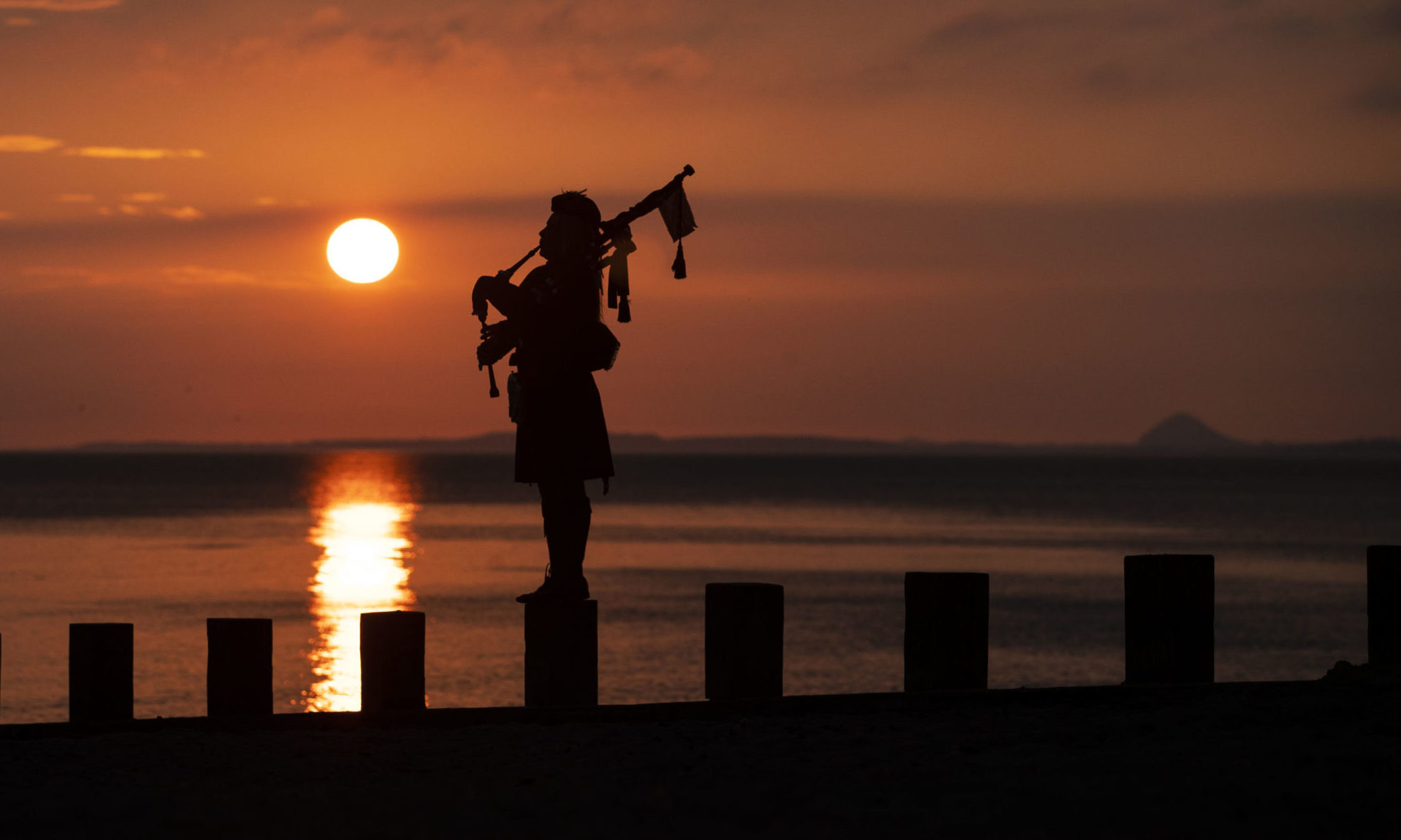 Piper Louise Marshall plays at dawn along Edinburgh's Portobello Beach