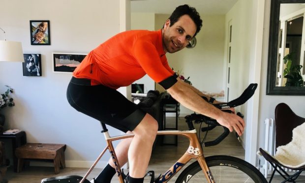 Mark Beaumont cycling in his living room