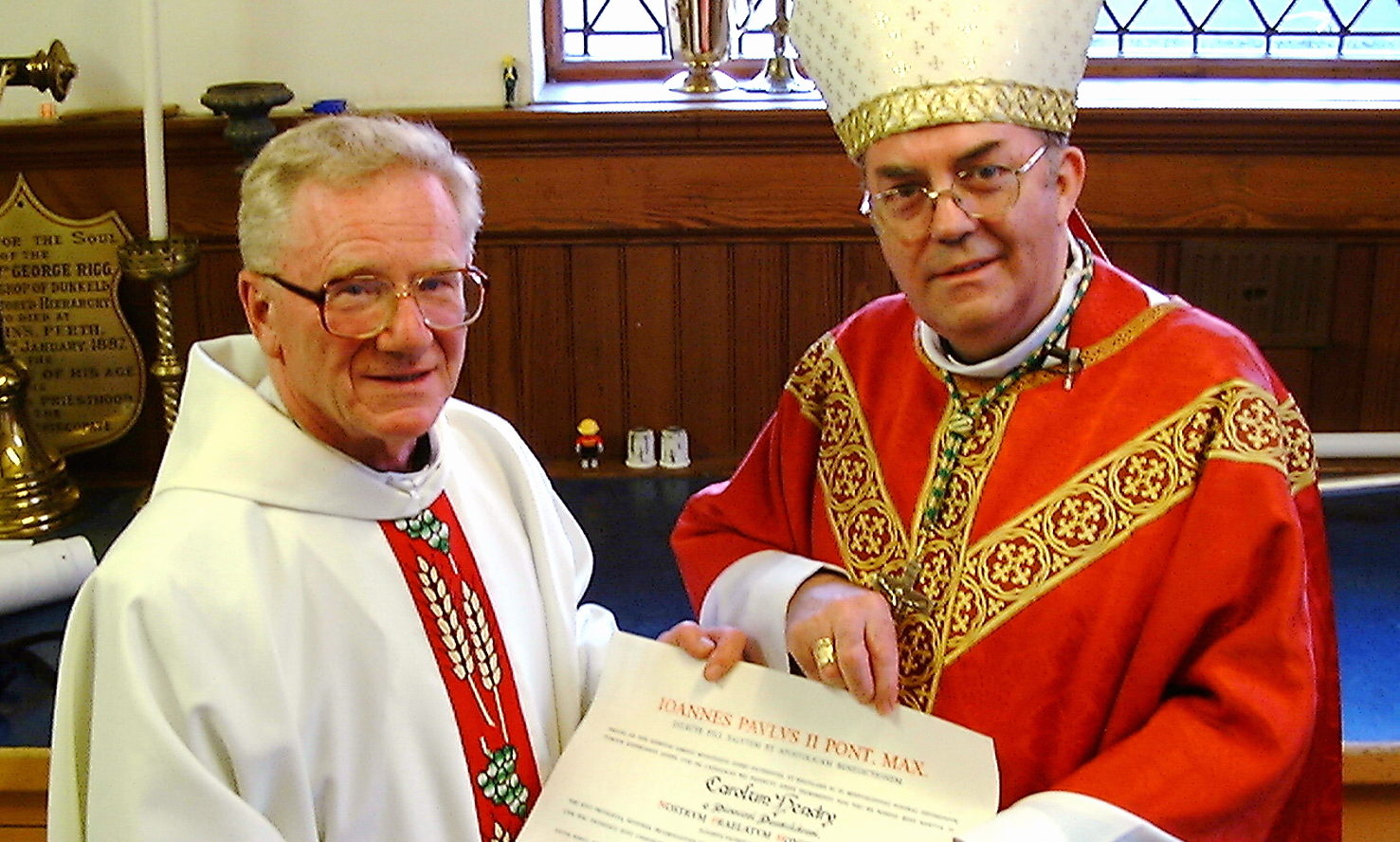 Monsignor Charles Hendry is presented withhis papal honour by Bishop Vincent Logan of Dunkeld in 2003.