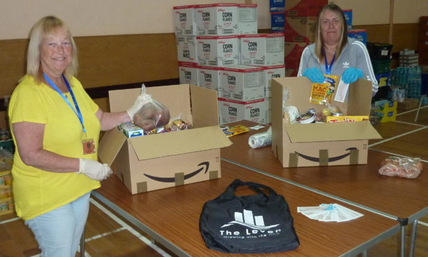 Rosemary Duncan and Vicky Skirving making food parcels at Levenmouth Food Hub and adding The Leven items encouraging engagement.