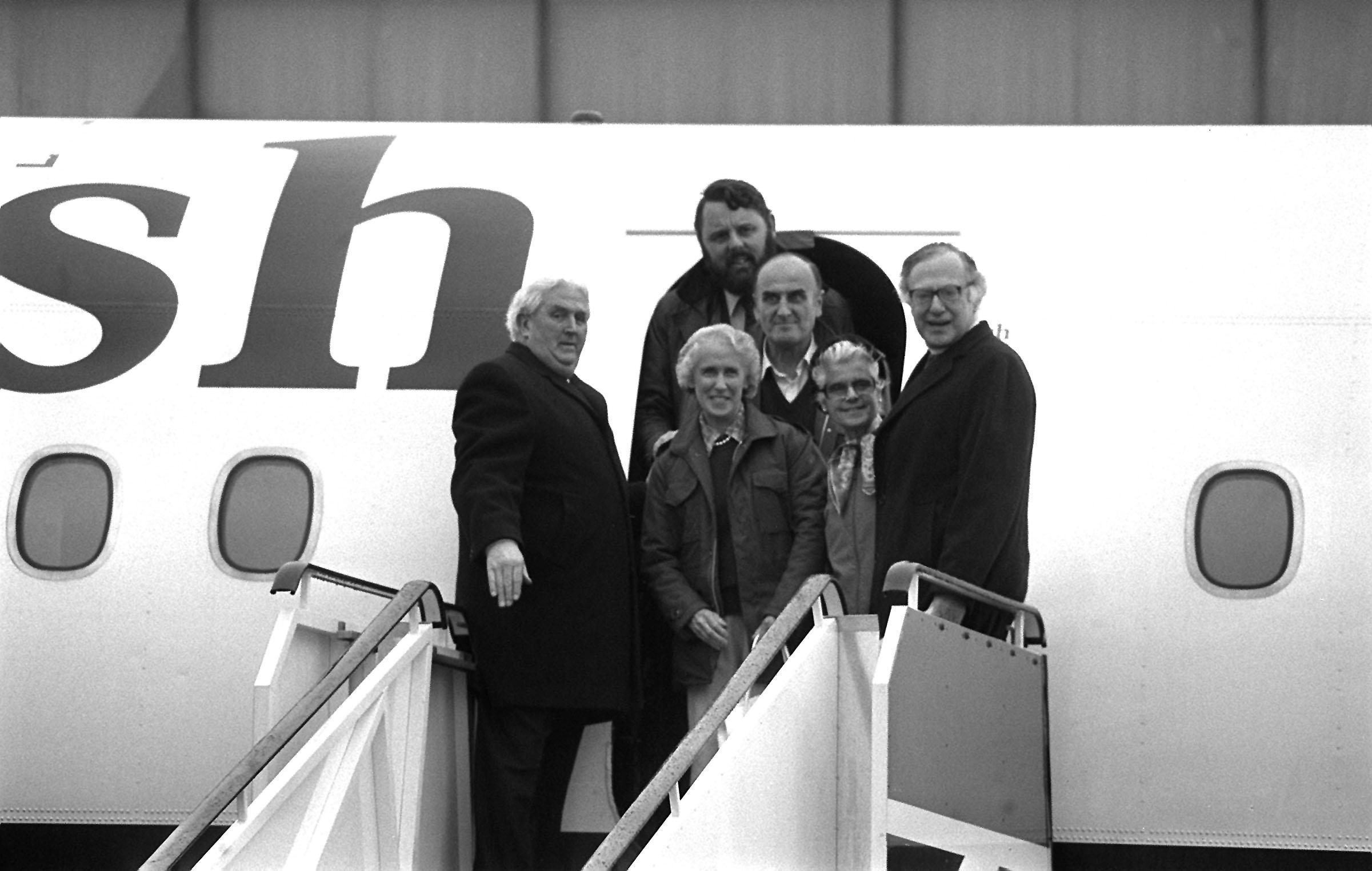 Miss Jean Waddell steps from the plane at Heathrow Airport after the release from captivity in Iran of the three Anglicans. Behind her is Mrs Audrey Coleman, with Dr John Coleman, her husband, Dr Runcie, the Archbishop of Canterbury and Terry Waite.