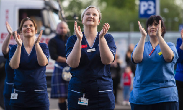 NHS Staff at the Queen Elizabeth Hospital clap for carers in early May