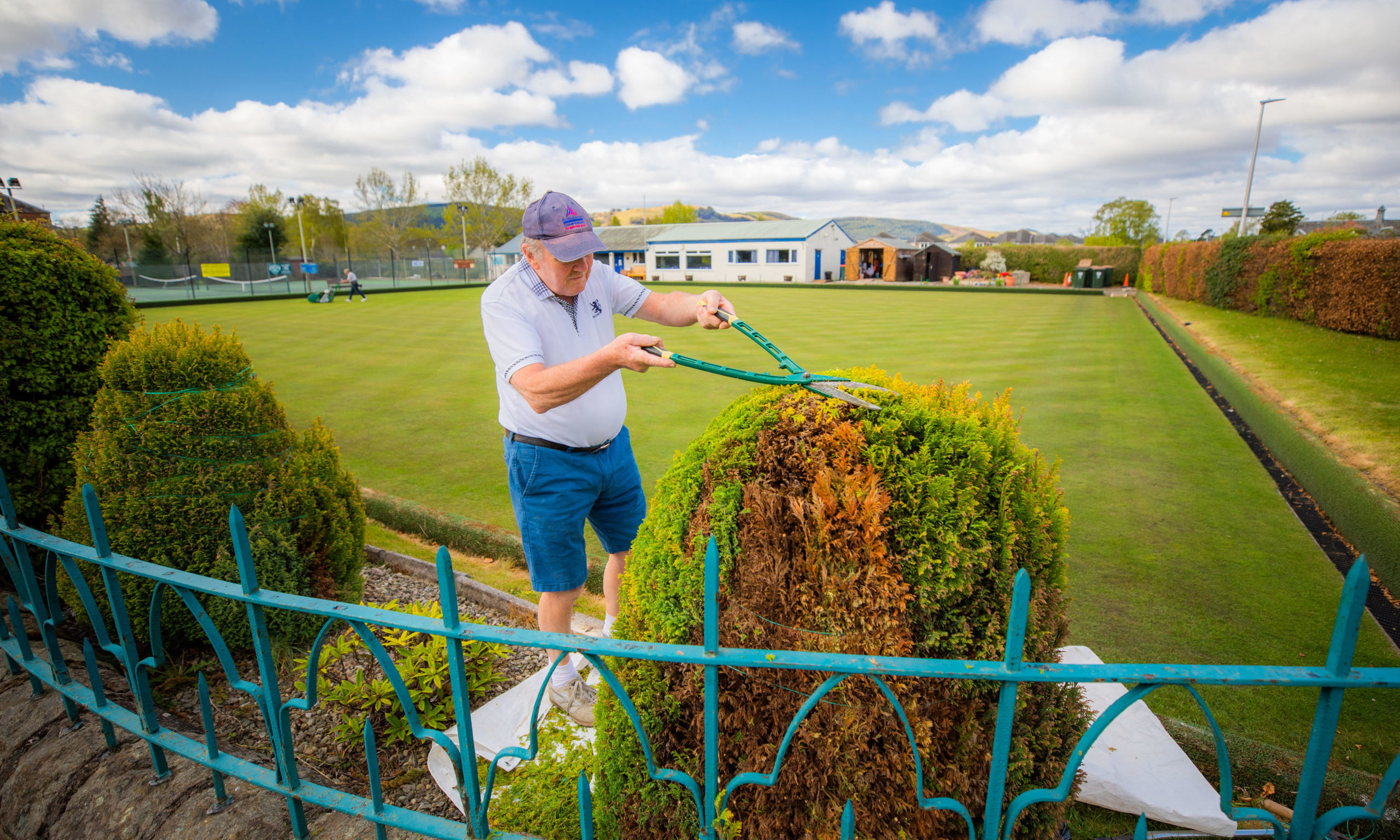 Members of the Bowling Club volunteering to maintain the grounds during lockdown.