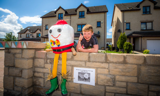 Jaxon Gahan, aged 10, with his Humpty Dumpty scarecrow.