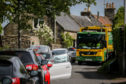 A Fife Council recycling truck struggles to pass parked vehicles lining the road leading to the entrance of Falkland Estate due to the car park being closed due to Covid-19 in May.