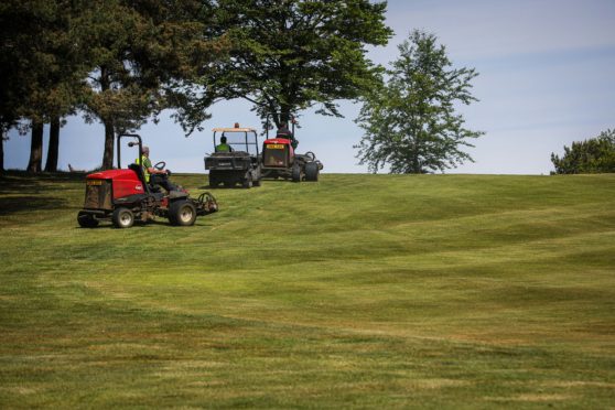 Greenkeepers get Dunnikier Park Golf Course ready for players to tee off on Friday.