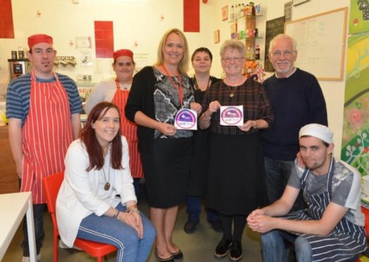 Chairman Ralph Dean (standind far right) with staff in happier times at the community cafe.