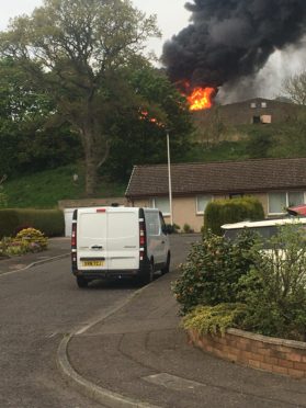 Fifefighters are dampening flames at the derelict shed in Barry, Carnoustie.