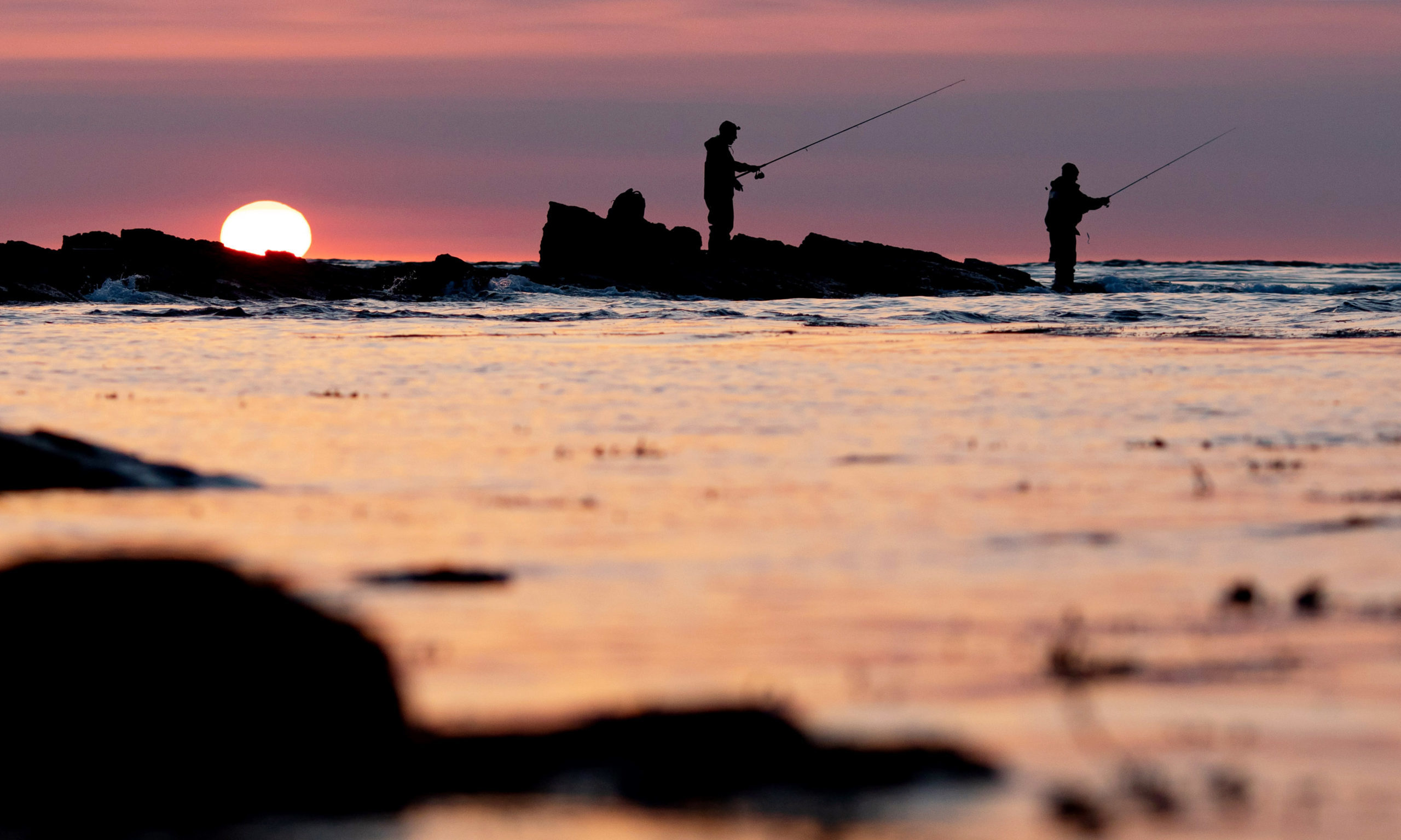 Mandatory Credit: Photo by James Marsh/Shutterstock (10661644d)
Two fishermen are seen at Peveril Point, Swanage as the sun rises.
Seasonal Weather, Peveril Point, Swanage, UK - 28 May 2020