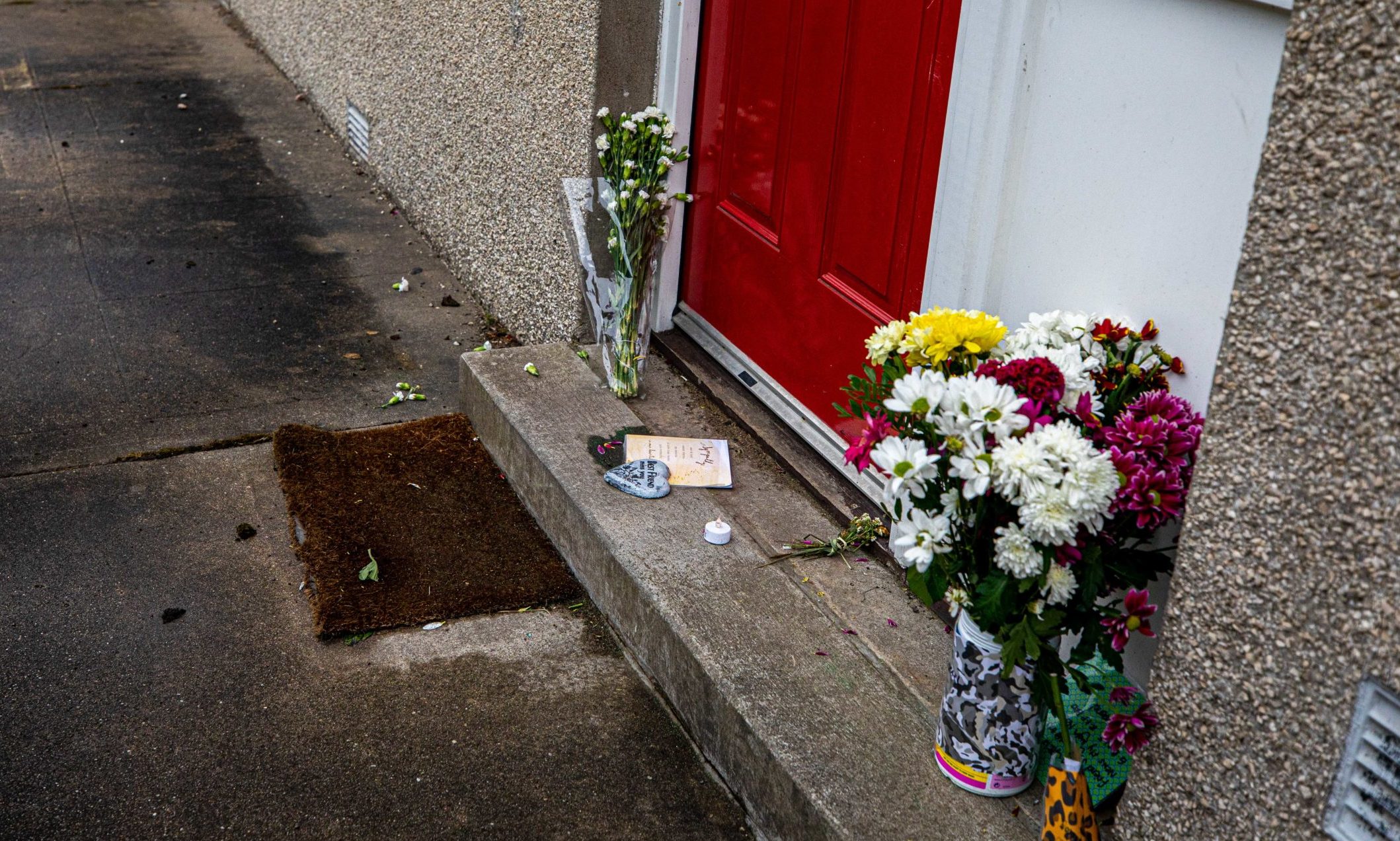 Floral tributes left at the house in Almondbank