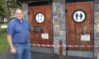 Councillor John Duff beside the closed public toilets at Aberfeldy