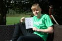 Josh Moran, 16, with his book published in aid of Macmillan. Picture: Dougie Nicolson.