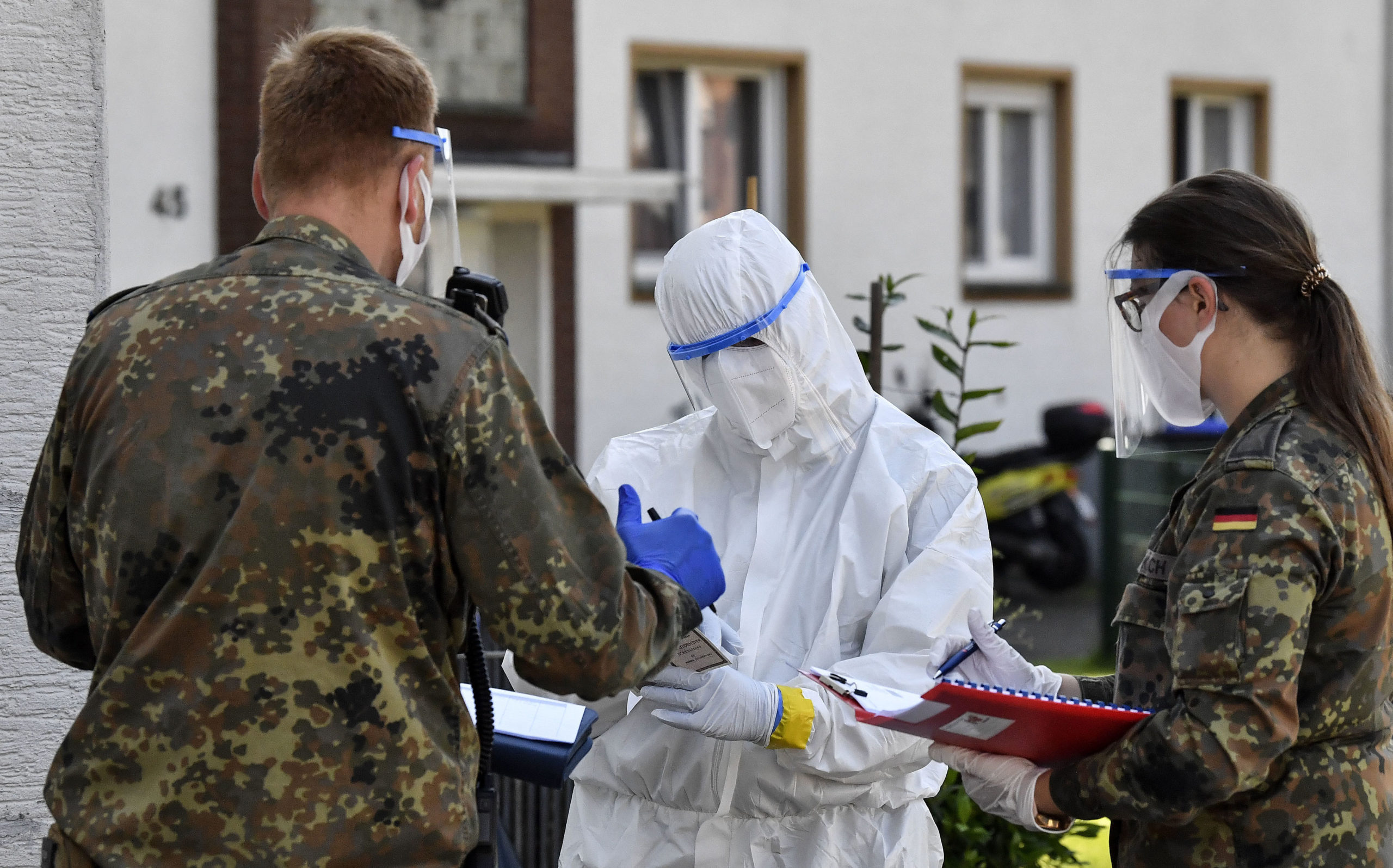 Medical staff and army members take Covid-19 tests of Tonnies employees and their families who are quarantined behind fences in Verl, Germany.