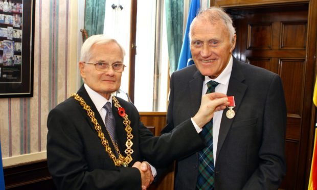 Frank Jordan received the British Empire Medal from Lord Provost Borthwick (left).