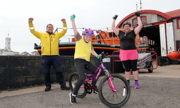 Kaylee celebrates at Arbroath lifeboat station with mum Dawn and Sam Clow, Arbroath RNLI coxswain/mechanic.