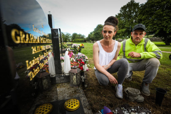 Graham's brother Scott Paterson, and Scott's partner Sarah Rodger at Graham's gravestone. Picture: Mhairi Edwards.