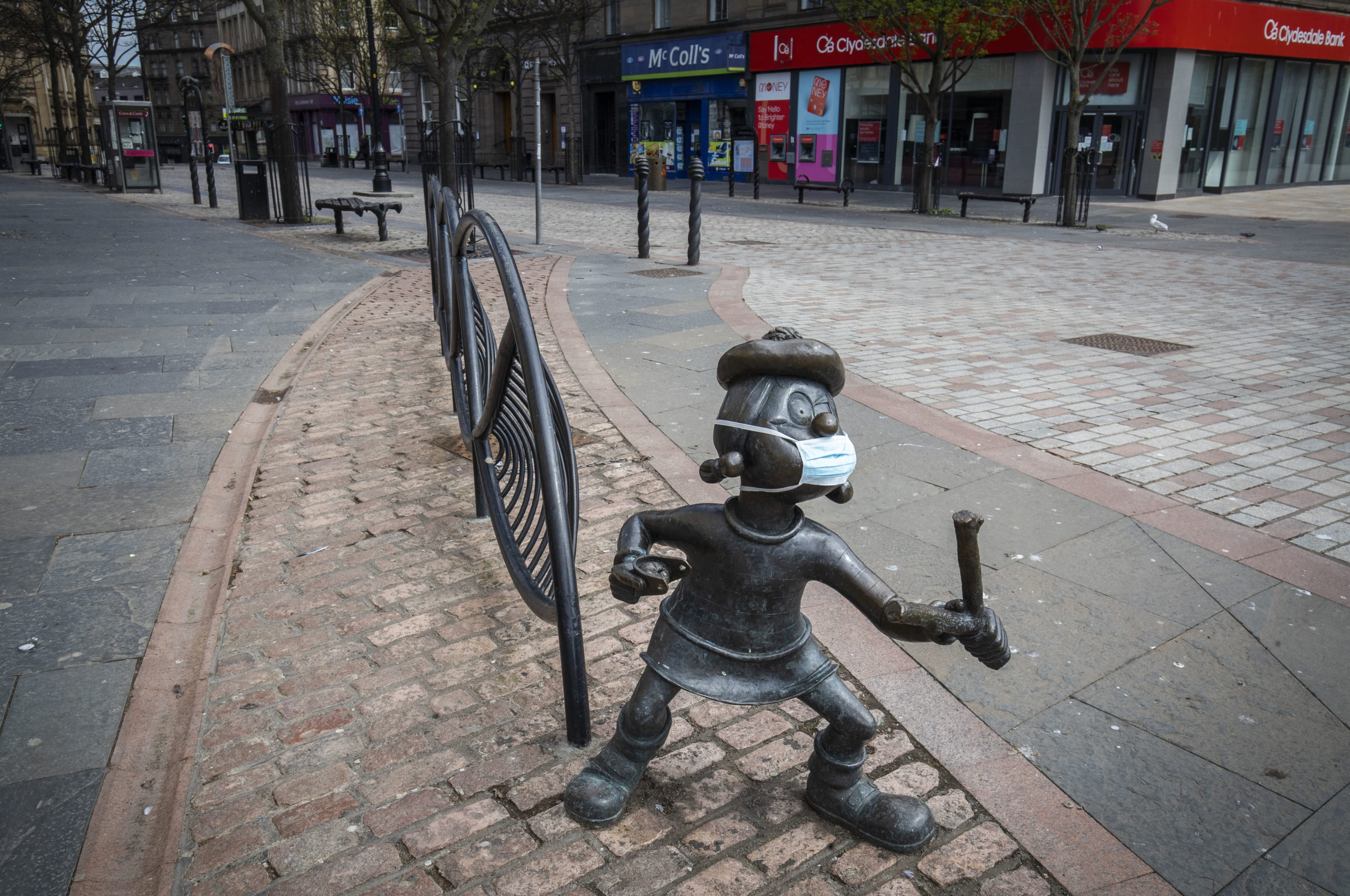 The statue of Beano character Minnie the Minx sports a protective face mask in Dundee city centre.