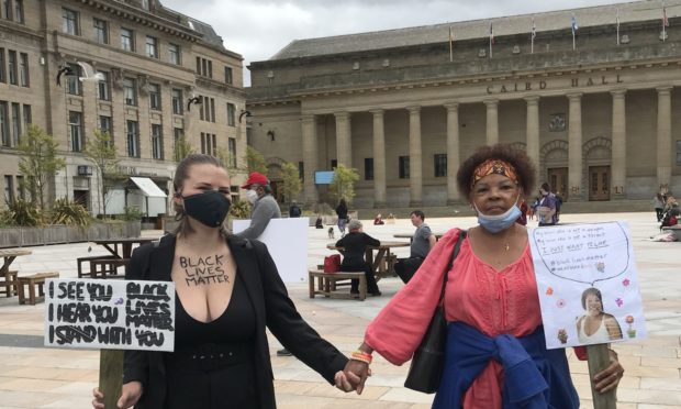 Lucie Lange, from Germany and Kathy McLemore of Ohio at the Dundee protest.