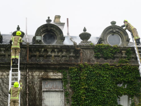 Firefighters on the roof of the main building at Letham Grange.