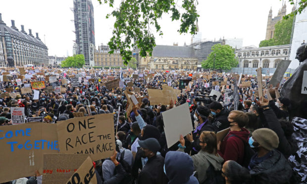 People take part in a Black Lives Matter protest rally in Parliament Square, London.