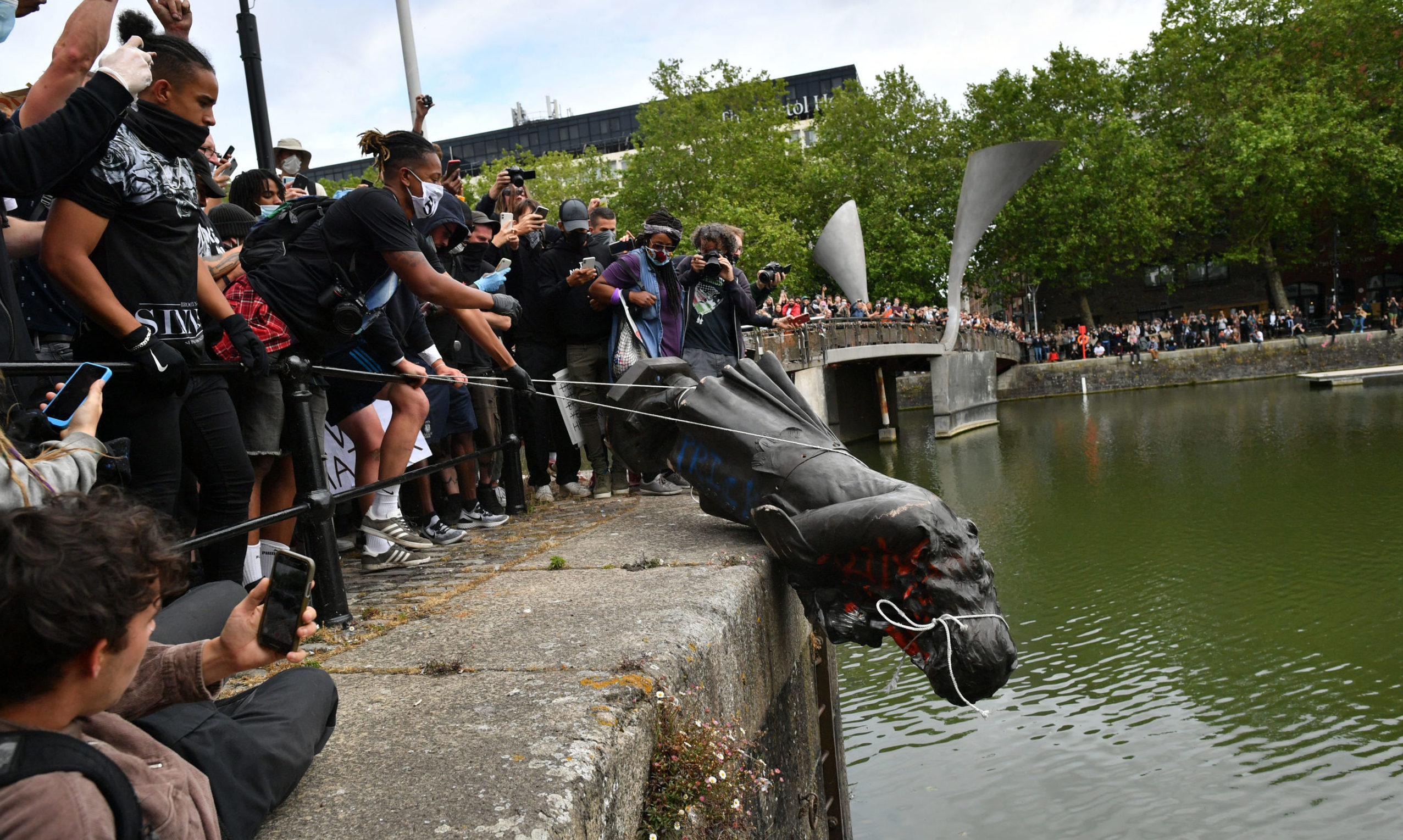 Protesters throw a statue of Edward Colston into Bristol Harbour during a Black Lives Matter protest rally.