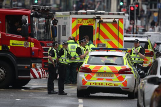 Emergency services at the scene in West George Street, Glasgow, where a man has been shot by an armed officer after another police officer was injured during an attack. PA Photo. Picture date: Friday June 26, 2020. See PA story POLICE WestGeorgeSt. Photo credit should read: Andrew Milligan/PA Wire