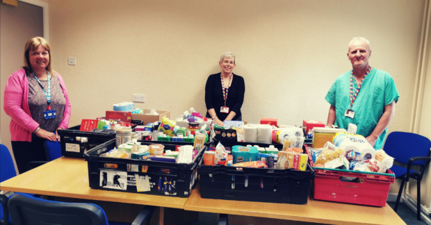 Medical Secretary, Jane Aitken, Medical Secretary, Lorna Robertson and Support Worker, John Coyle with foodbank donations.