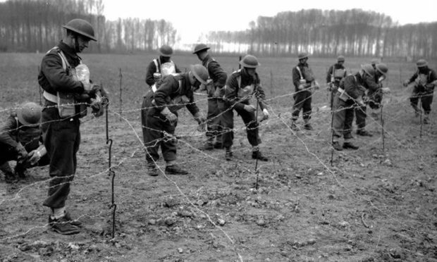 Royal Scots soldiers laying down barbed wire after the 1st Battalion was told to fight until the last man stood to allow evacuation from Dunkirk.