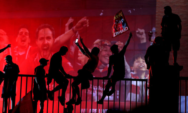 Liverpool fans celebrating outside Anfield, Liverpool, after the football club won the Premier League.