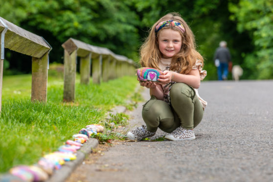 Gracie Gilmour from Leslie placing stone on the 'snail trail' at Gilvenbank Park.