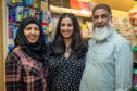 Miriam Hussain with parents Fatima and Fateh at the family business.