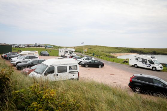 Campervans and cars filling up the car park and roadside as tourists arrive in Campervans to enjoy Fife.