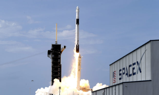A SpaceX Falcon 9, with NASA astronauts Doug Hurley and Bob Behnken in the Dragon crew capsule, lifts off from Pad 39-A at the Kennedy Space Center in Cape Canaveral on May 30