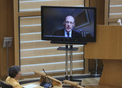 Deputy First Minister and education secretary John Swinney remotely joining topical questions at the Scottish Parliament.