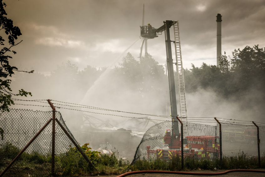 The fire service dousing the building on the morning of Monday, June 8.