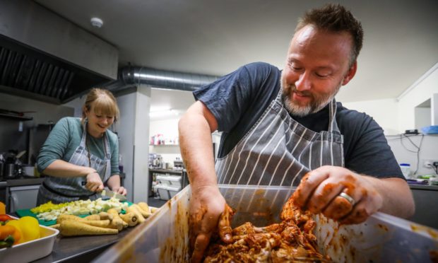 Skills Development Officer Laura Connacher and CEO Gareth Ruddock marinating bbq chicken for some of the meals.